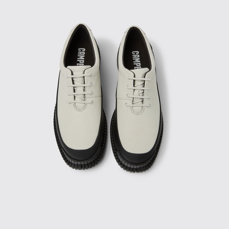 Overhead view of Pix White and black leather lace-up shoes