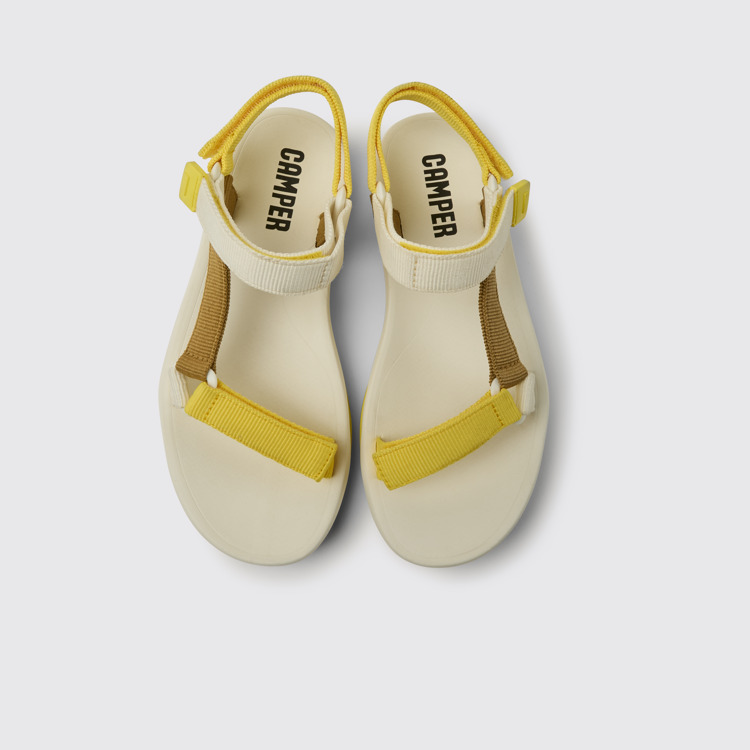 Overhead view of Match Yellow, white, and brown sandals for women