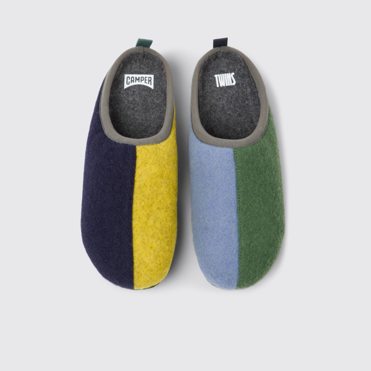 Overhead view of Twins Blue, yellow, and green wool slippers for women