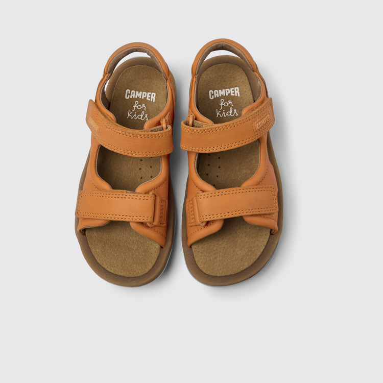 Overhead view of Bicho Orange leather sandals for kids