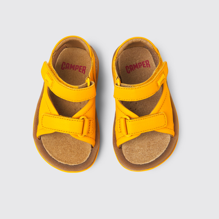 Overhead view of Bicho Yellow leather sandals for kids