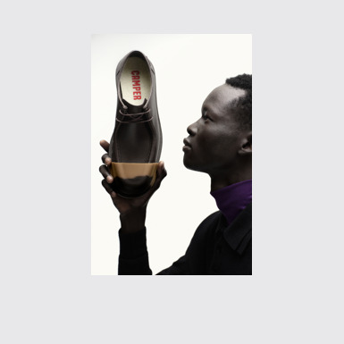 A model wearing Junction Brown Leather Men's Shoe.