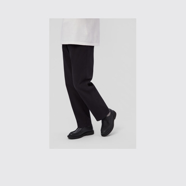 A model wearing Norman Black Leather Shoes for Men.