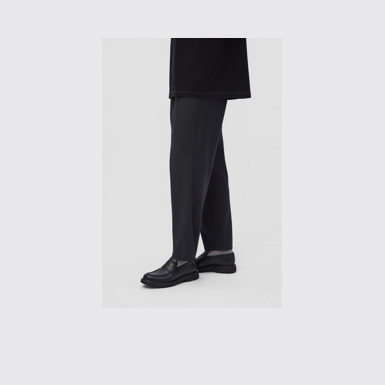A model wearing Norman Black Leather Shoes for Men.