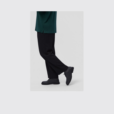 A model wearing Pix Black Leather Shoes for Men.