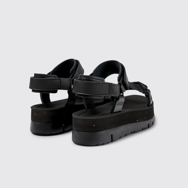 Back view of Oruga Up Black leather sandals for women