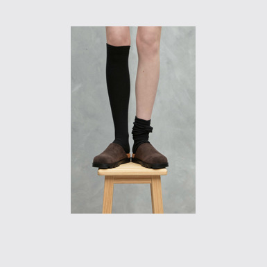 A model wearing Brutus Sandal Gray Nubuck Clog for Women