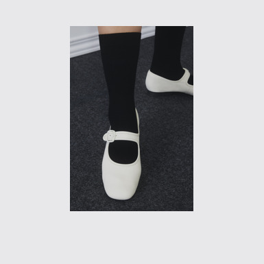 A model wearing Casi Myra White Leather Women's Shoe.