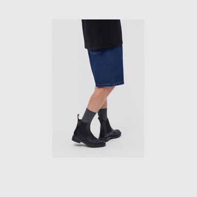 A model wearing Dean Black Leather Ankle Boots for Men.