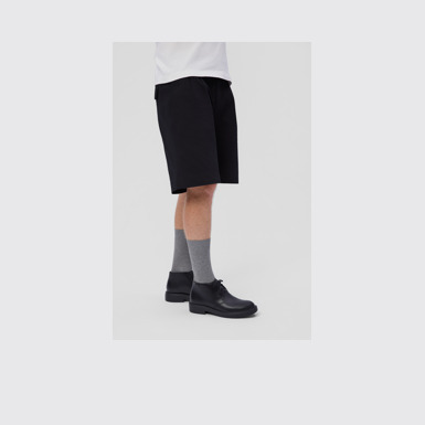 A model wearing Dean Black Leather Ankle Boots for Men.
