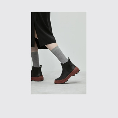 A model wearing Brutus Trek Black nubuck ankle boots for women