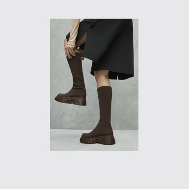 A model wearing BCN TENCEL® Brown textile boots for women