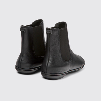 Back view of Right Black leather ankle boots