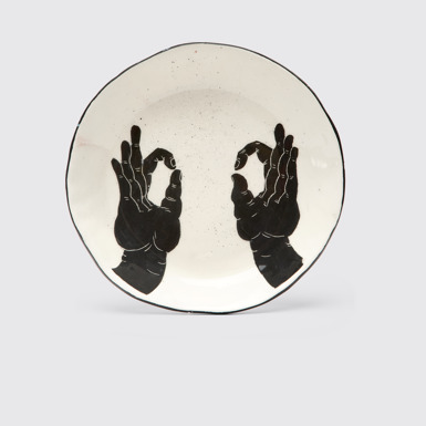 Side view of Ceramic plate with hands White and black handmade plate