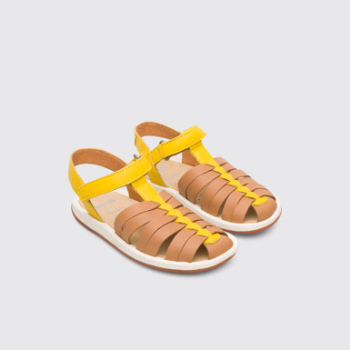 Front view of Bicho Closed yellow and tan nude T-strap sandal for kids