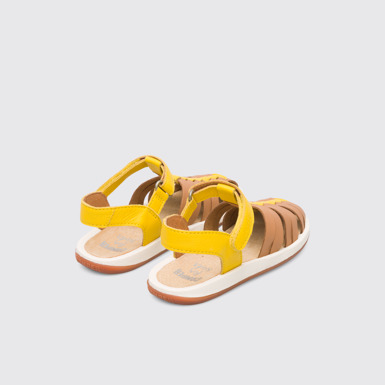 Back view of Bicho Closed yellow and tan nude T-strap sandal for kids