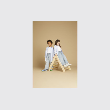 A model wearing Drift Trail White Textile/Nubuck Sneaker
