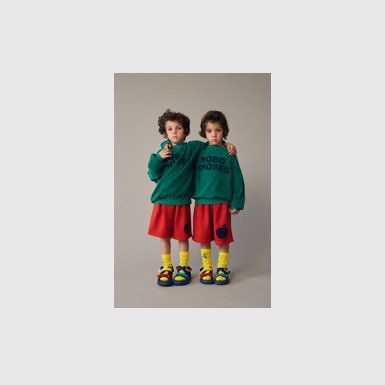 A model wearing Bobo Choses x Camper Multicolor Textile Sandals for Kids.