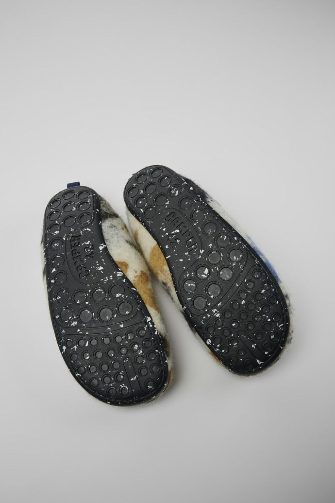 The soles of Wabi Blue and black recycled wool slippers for men