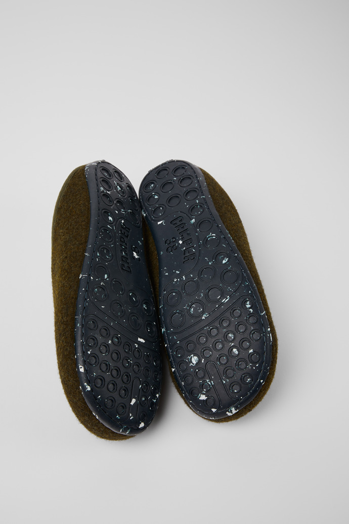 The soles of Wabi Green wool slippers for women