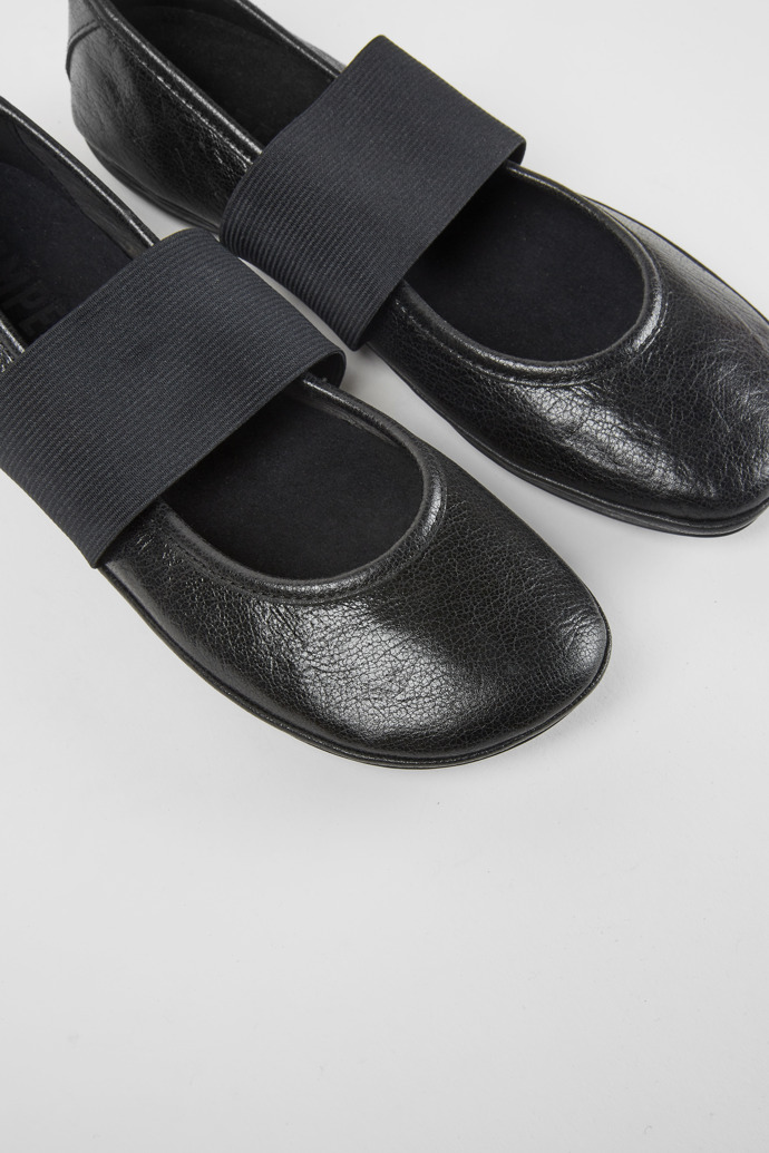 Close-up view of Right Black leather ballerina shoes