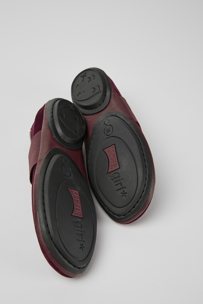 The soles of Right Burgundy ballerina shoes