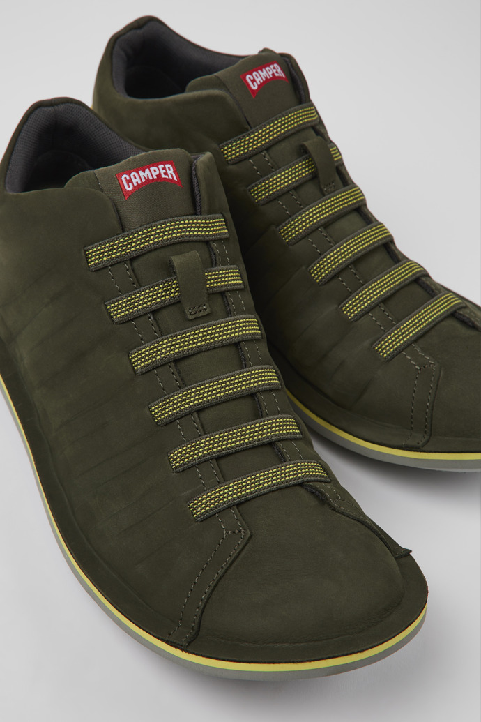 Close-up view of Beetle Green nubuck sneakers