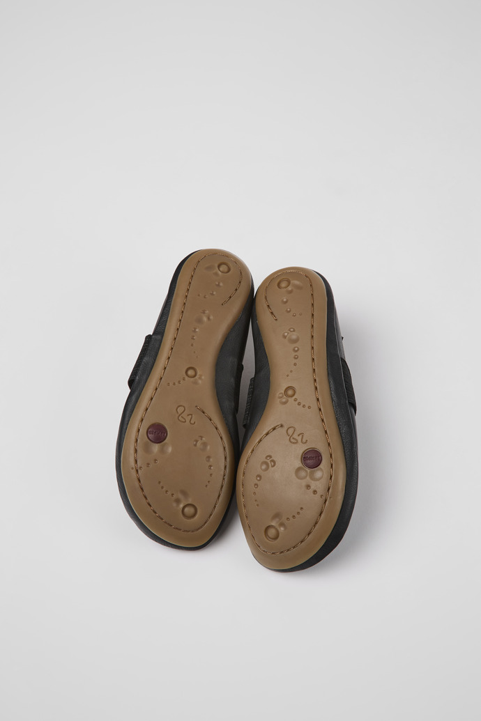 The soles of Right Black leather ballerinas for kids