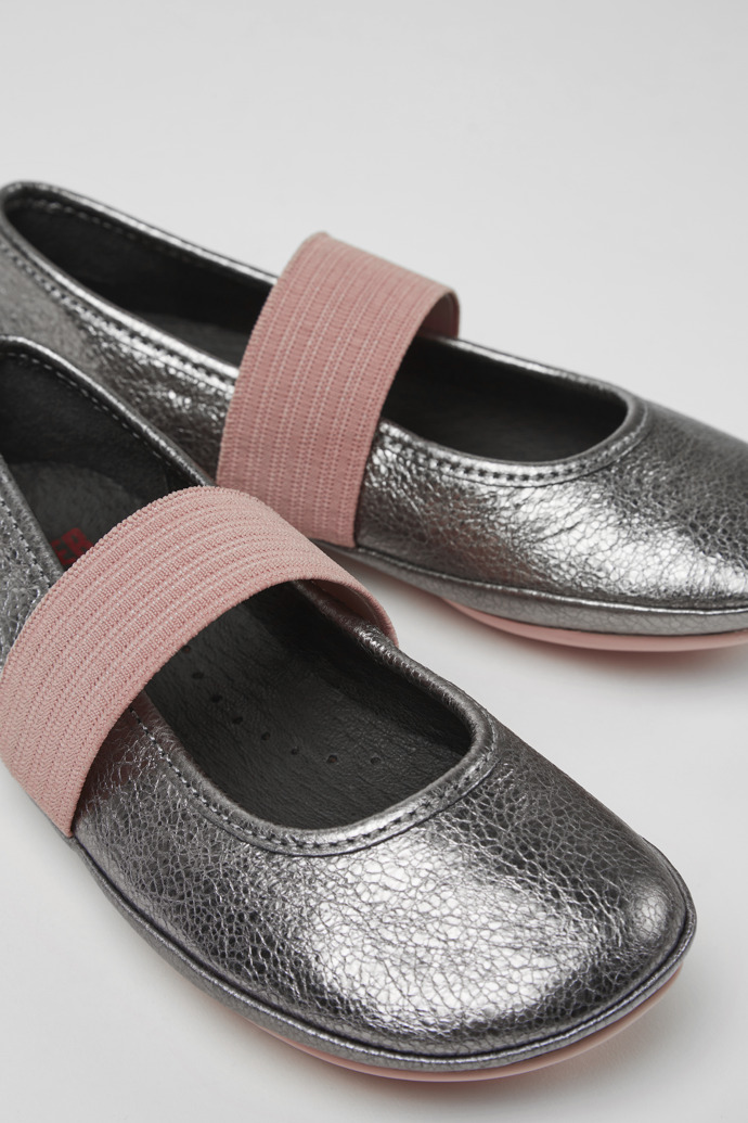 Close-up view of Right Silver and pink leather ballerinas