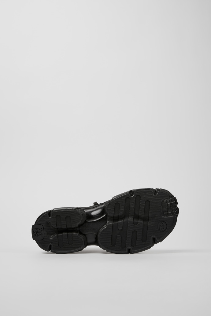 The soles of Tossu Black caged sneakers