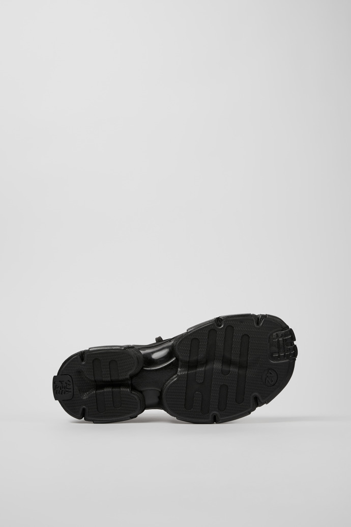 The soles of Tossu Black Caged Sneakers