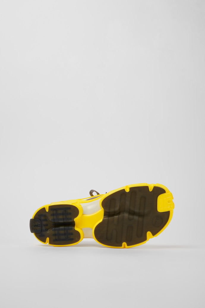 The soles of Tossu Yellow caged sneakers