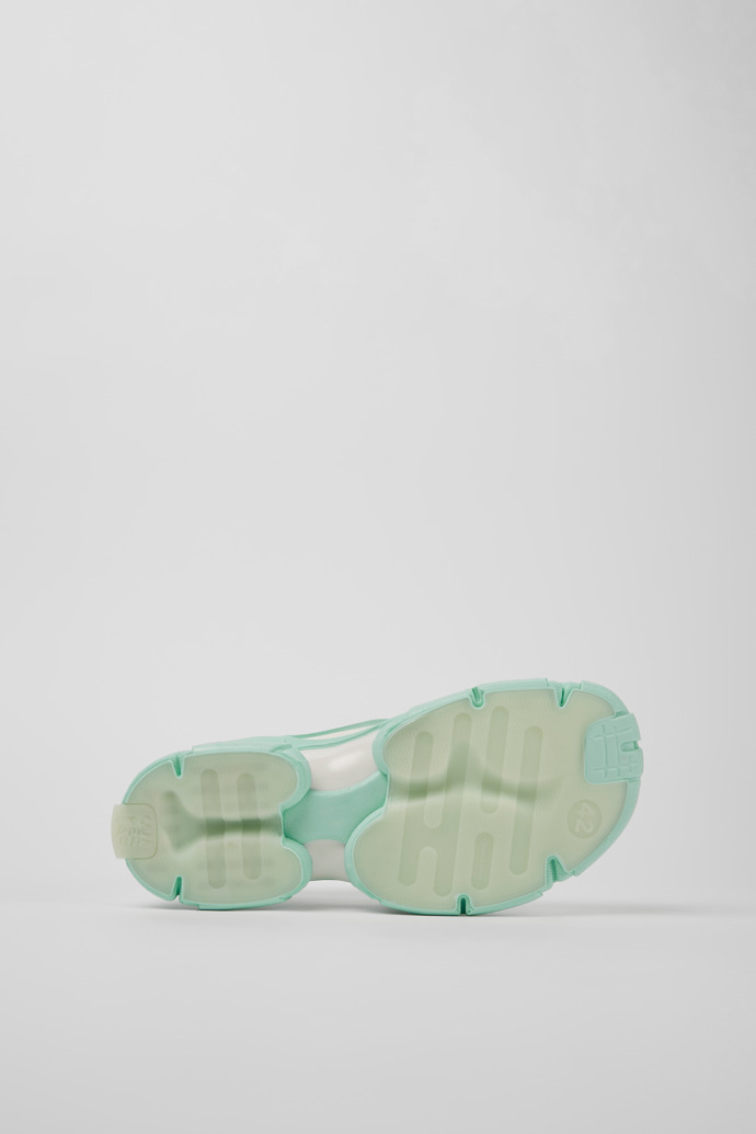 The soles of Tossu Light green caged sneakers