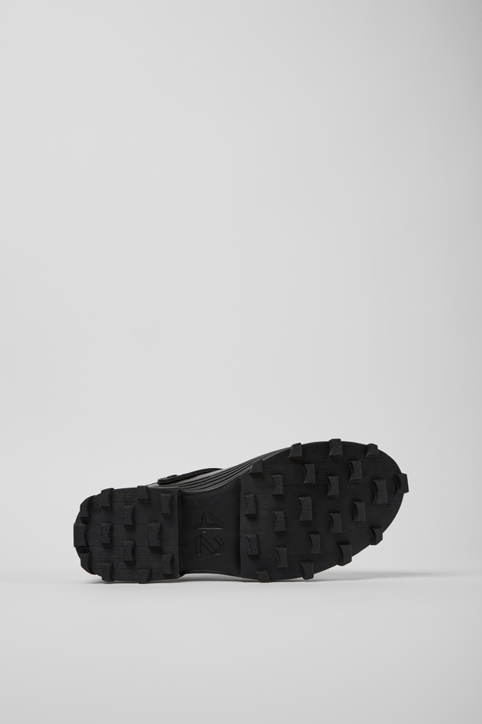 The soles of Traktori Black leather clogs