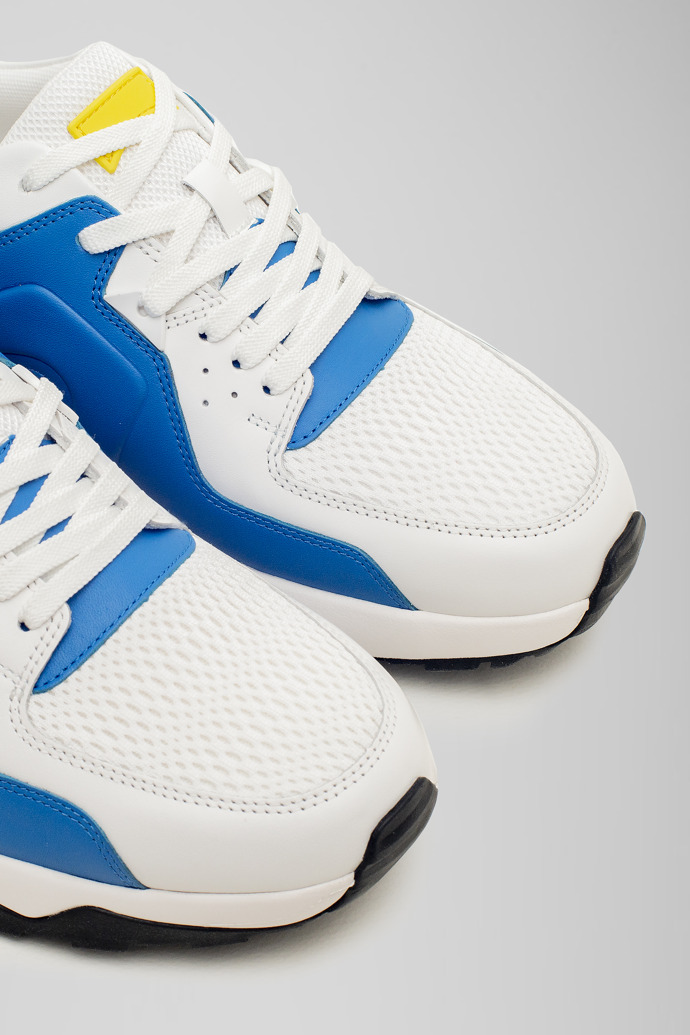 Close-up view of Caddie White and blue golf sneakers
