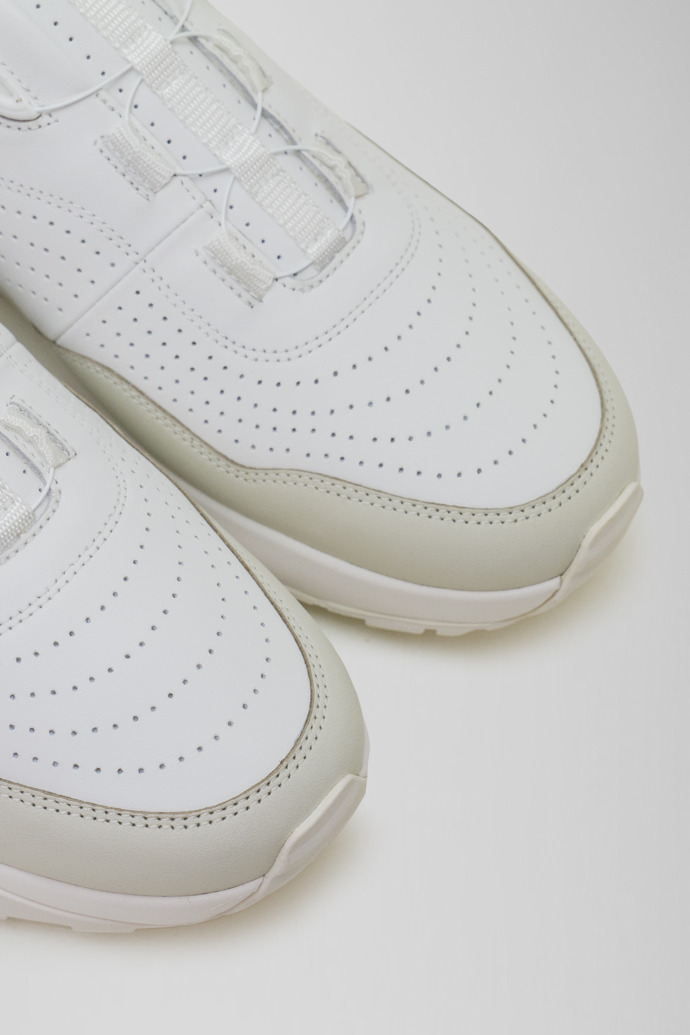 Close-up view of Looper White and light gray leather golf sneakers