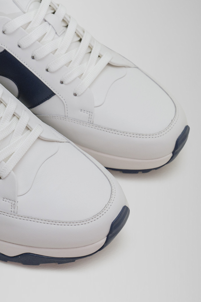 Close-up view of Spackler White and navy leather golf sneakers