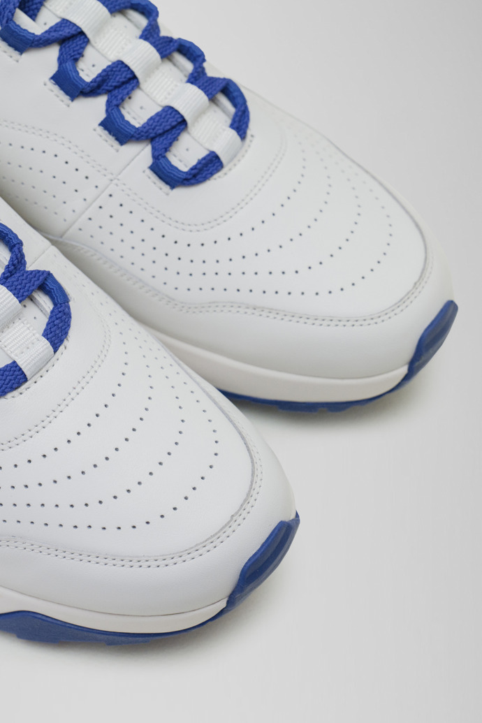 Close-up view of Looper White and navy leather golf sneakers