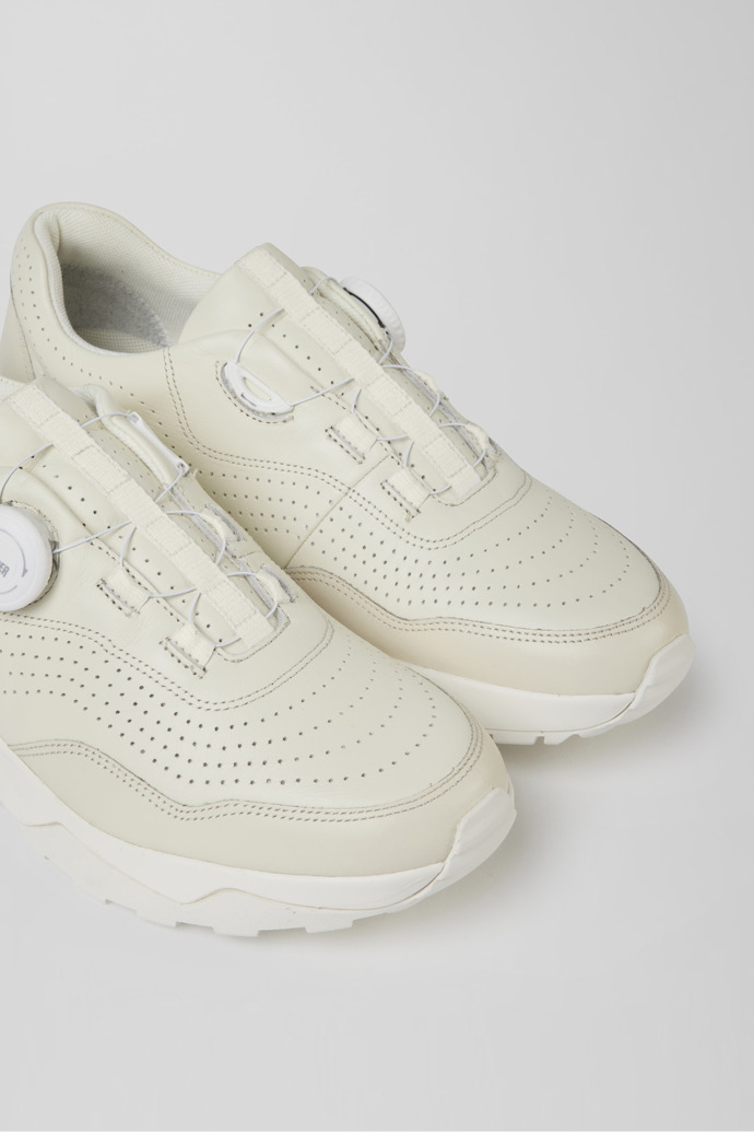 Close-up view of Looper Ivory white  leather golf sneakers