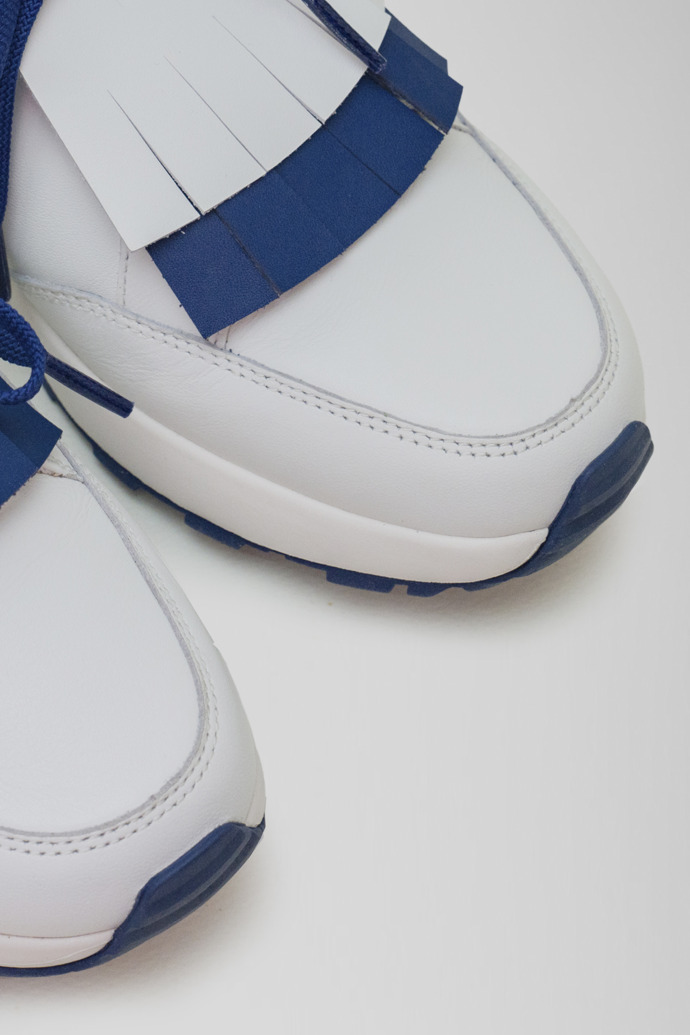 Close-up view of Spackler White and navy leather golf sneakers