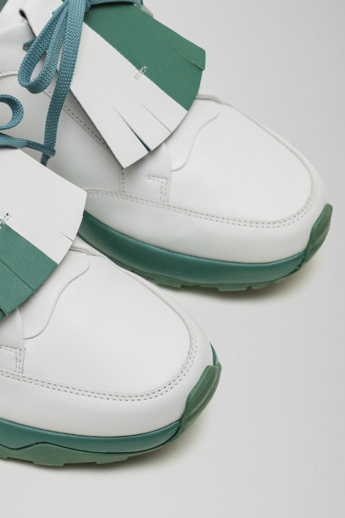 Close-up view of Spackler White and green leather golf sneakers