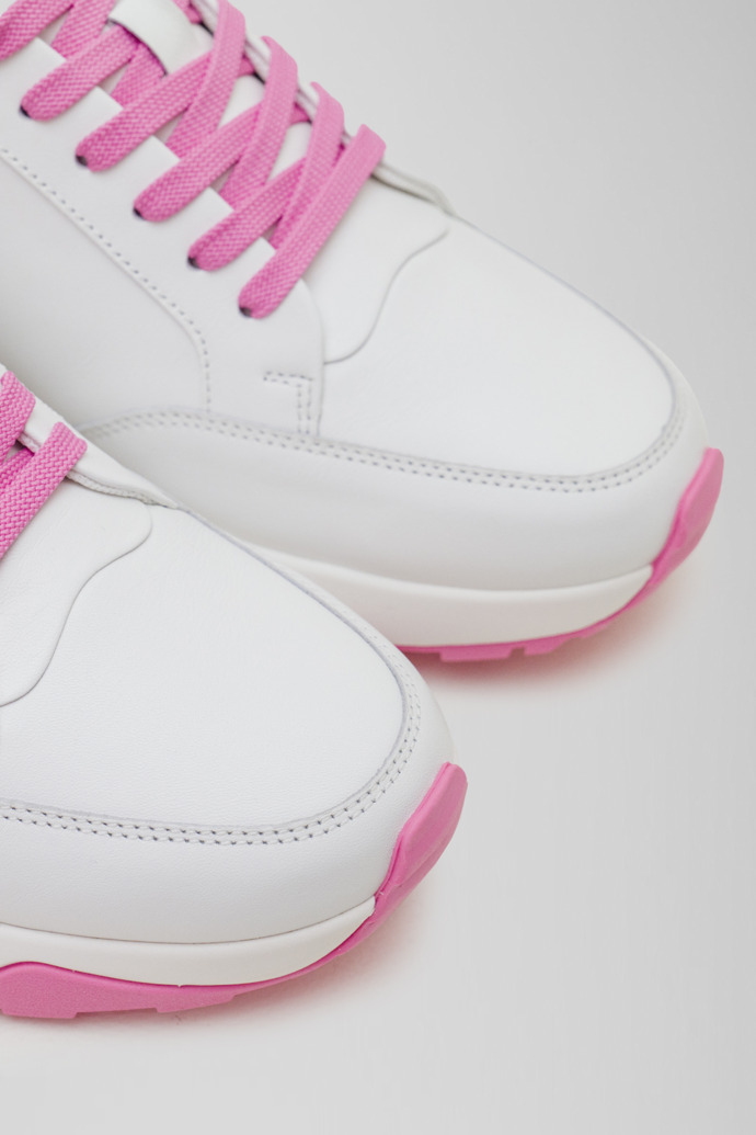 Close-up view of Spackler White and pink leather golf sneakers