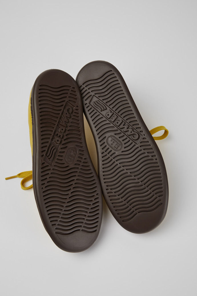 The soles of Runner Yellow leather sneakers
