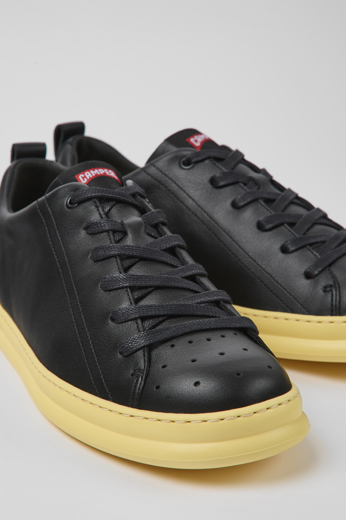 Close-up view of Runner Black and yellow leather sneakers for men