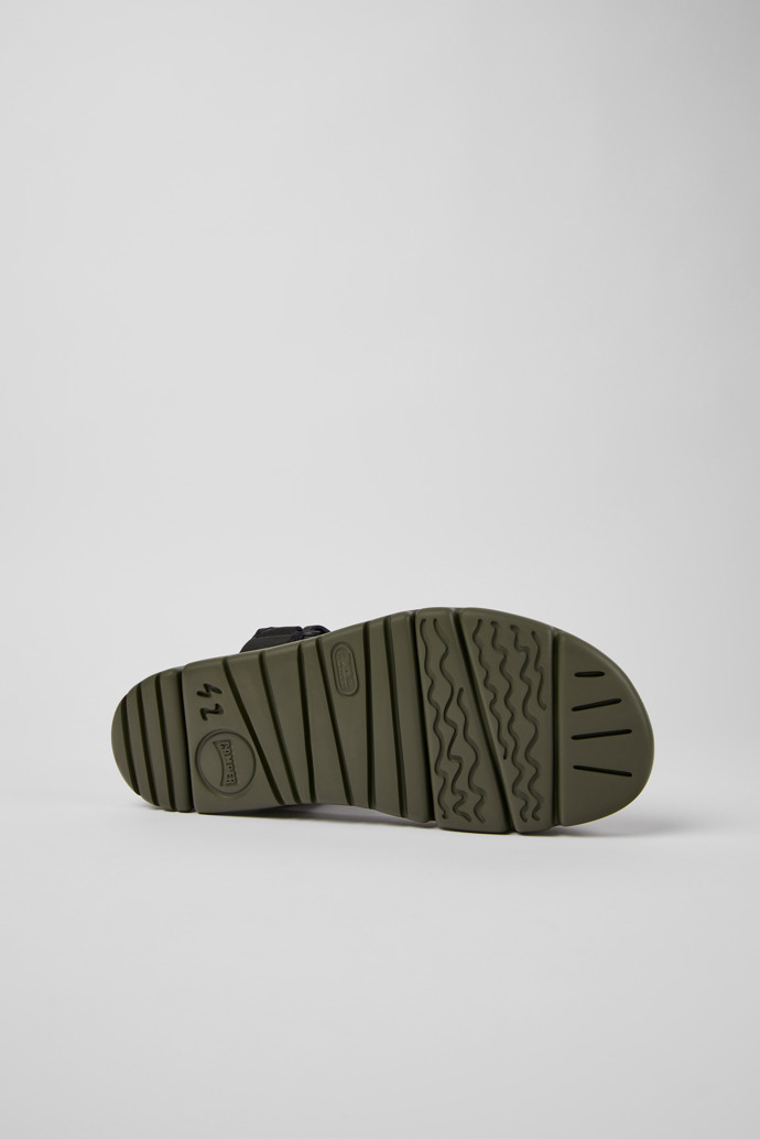 The soles of Oruga Black leather sandals for men