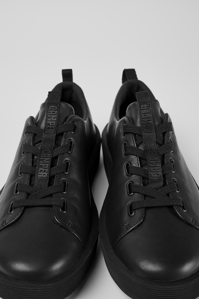 Close-up view of Courb Black leather sneakers for men