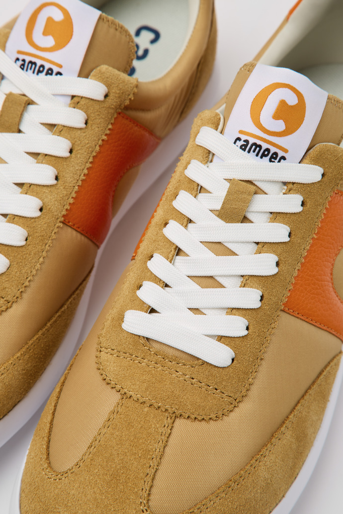 Close-up view of Pelotas XLite Brown and orange sneakers for men