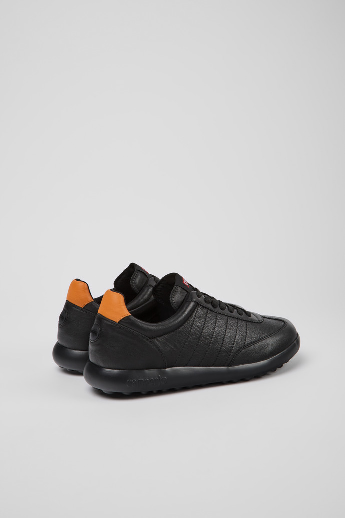 Back view of Pelotas XLite Black and orange sneakers for men