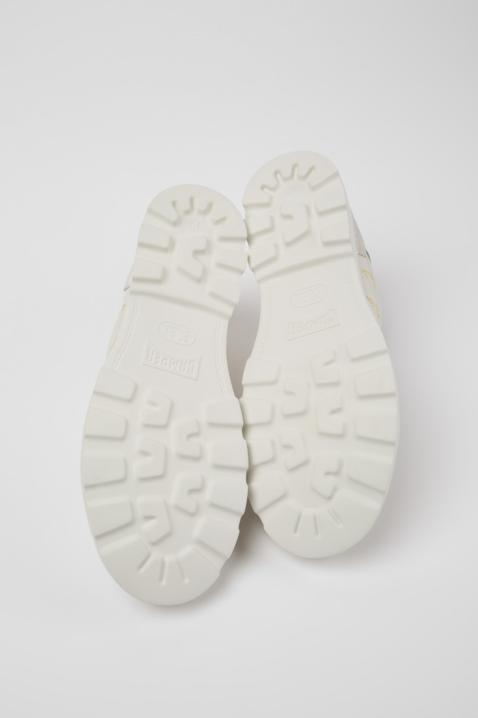 The soles of Brutus Sneaker for men in white, grey and green
