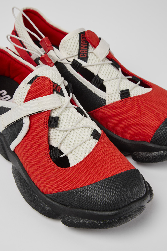 Close-up view of Karst White, black, and red textile shoes for men